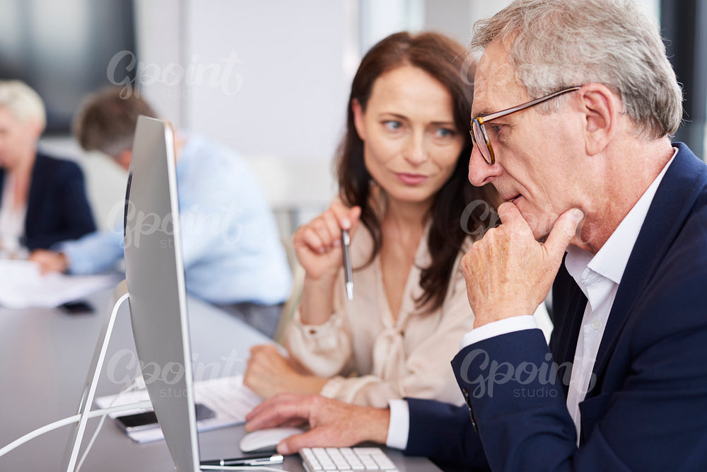 Busy businessman using a computer during business meeting