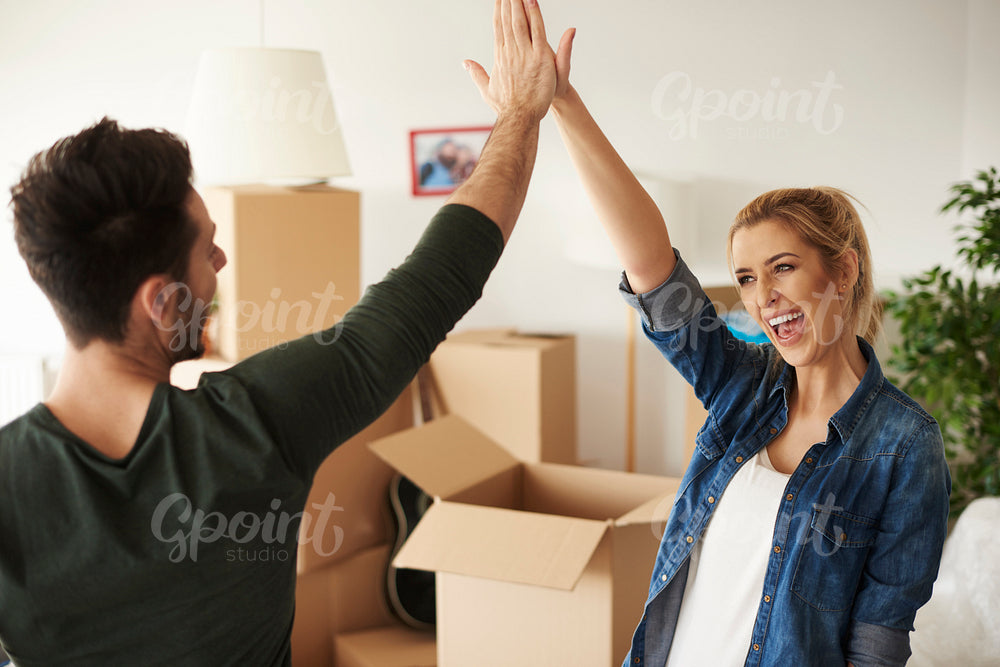 Happy and young couple giving high five