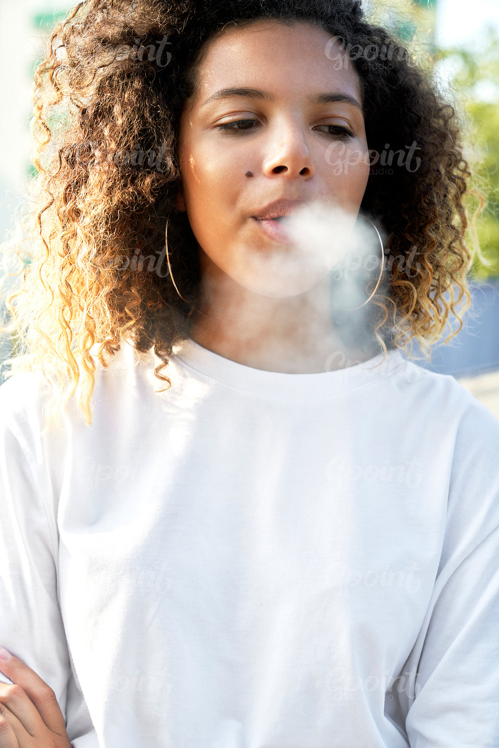 Young woman standing and smoking cigarette