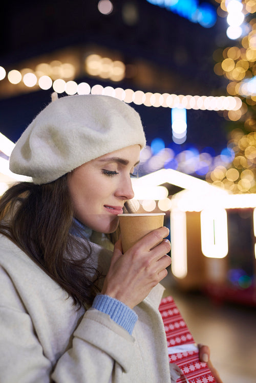 Close up of woman drinking mulled wine on cold night