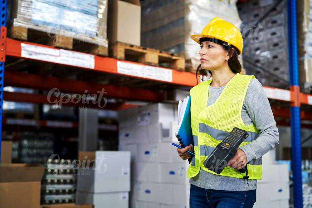 Adult caucasian woman working in warehouse 