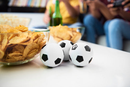 Detail of balls and potato chips on the table
