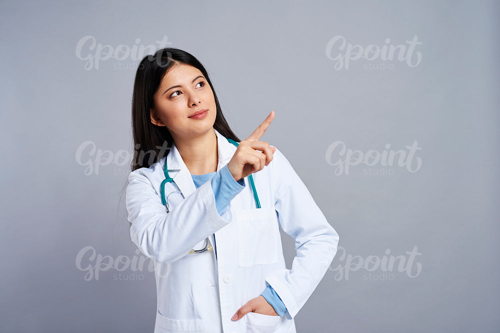 Female doctor pointing at the space