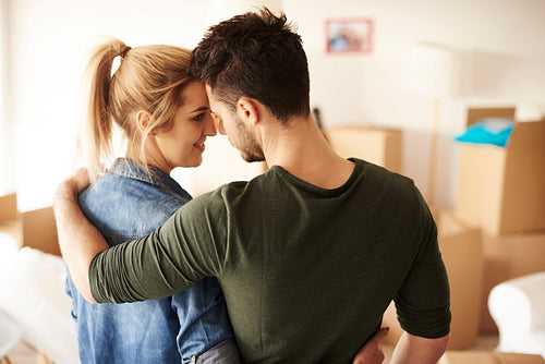 Romantic view of couple cheering in new home