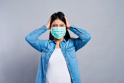 Paranoid Asian woman in protective mask