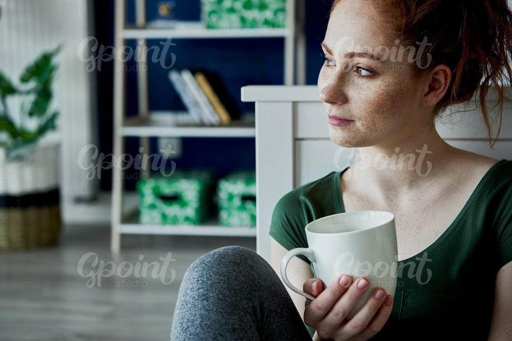 Nostalgic young woman and a cup of tea
