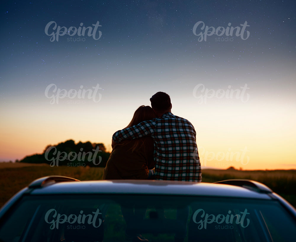 Rear view of loving couple enjoying the view at night