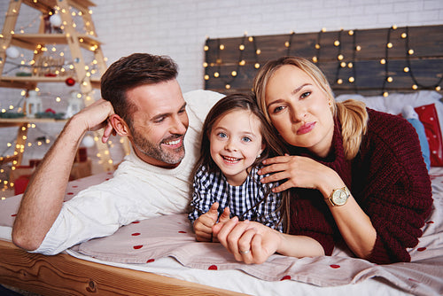 Portrait of happy family in bed at Christmas