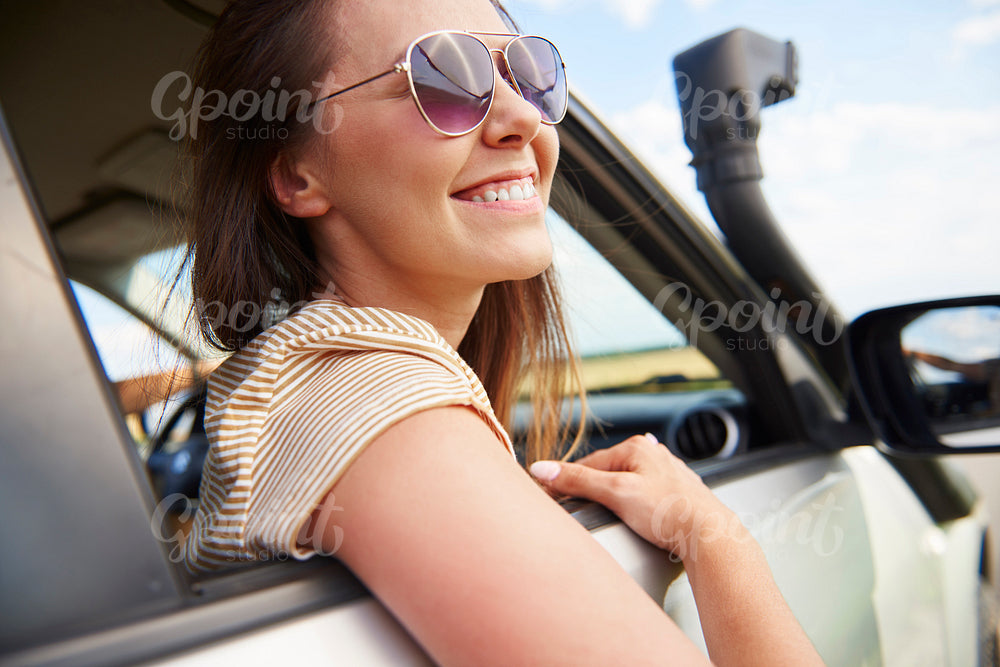 Smiling young woman looking at view during road trip