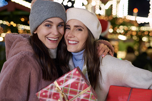 Portrait of women outdoors with Christmas gift