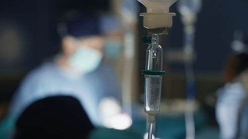 Intravenous drip infusion and surgeon over surgery