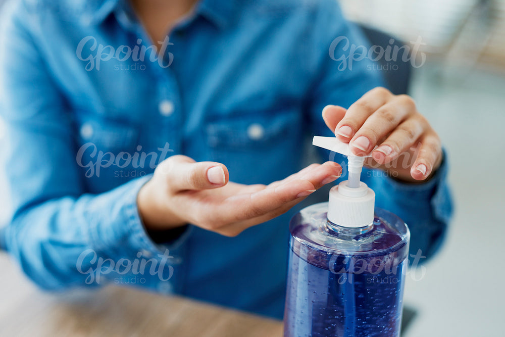 Close up of hands using a  cleaning product