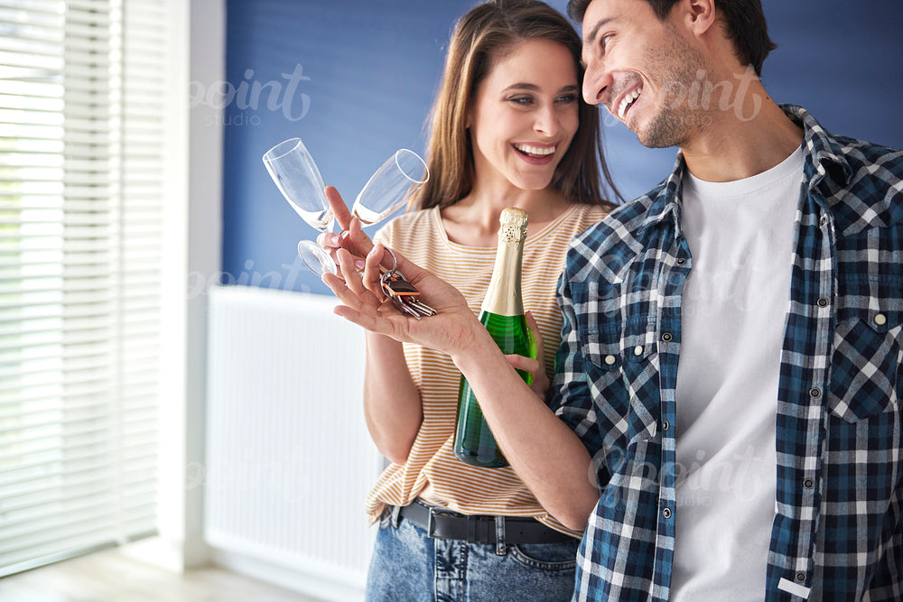Couple with champagne celebrating home ownership