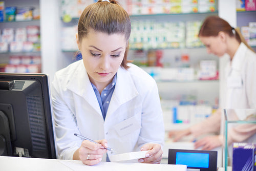 Female pharmacist working in drugstore