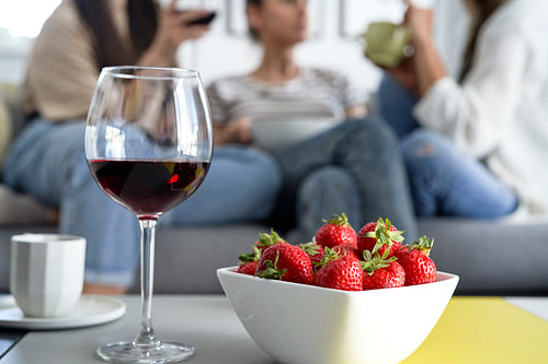 Red wine and bowl full of fresh strawberries