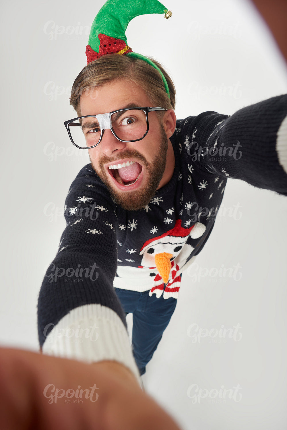 Man in Christmas clothes taking a selfie