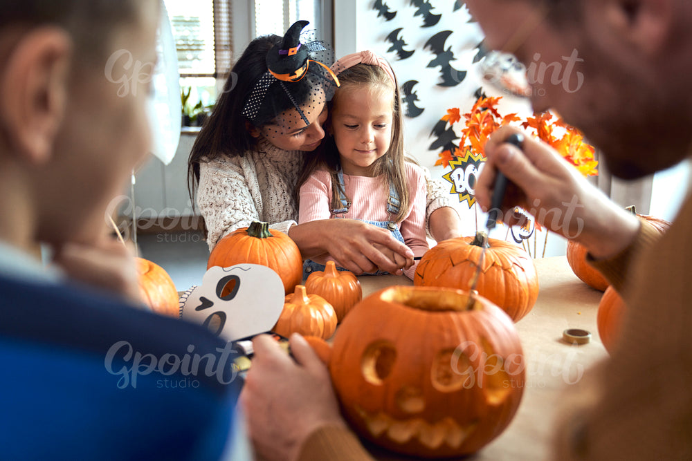 Family making jack-o-lantern for Halloween