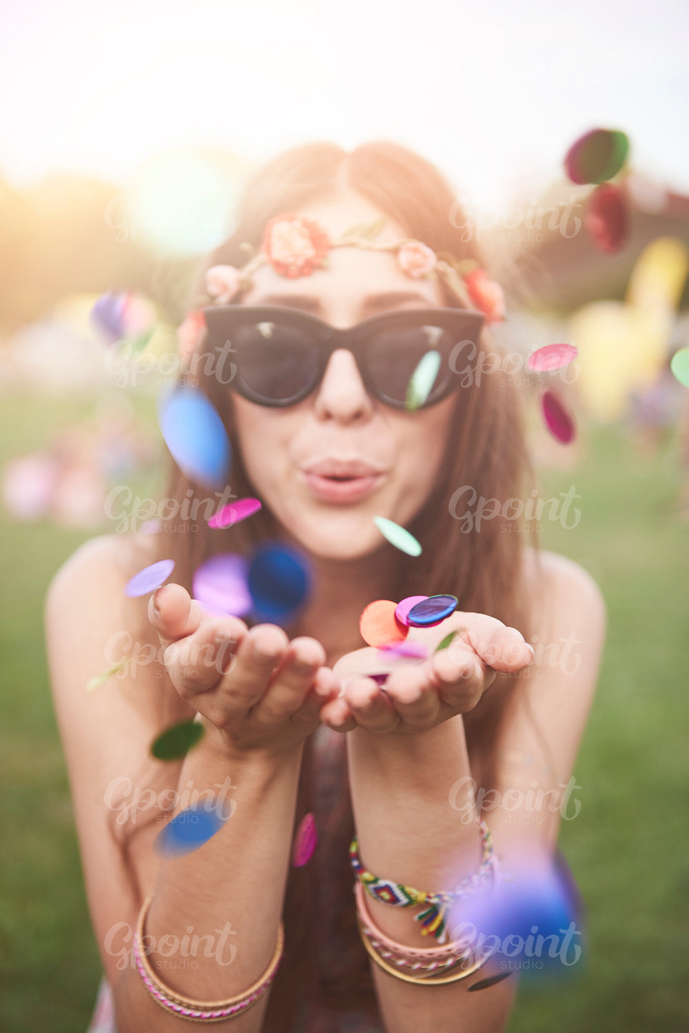 Colorful confetti blew by girl