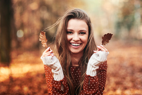 Happy beautiful woman have fun in the forest autumn