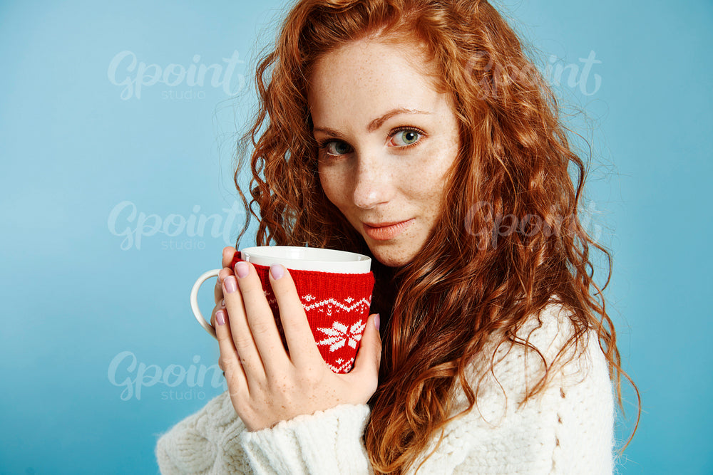 Portrait of beautiful girl drinking hot tea or coffee