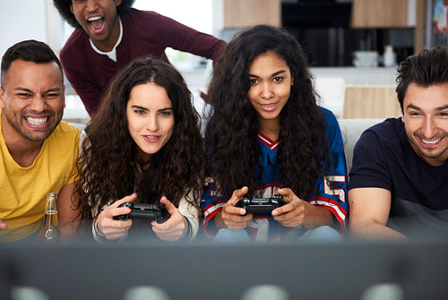 Front view of group of friends playing on the console