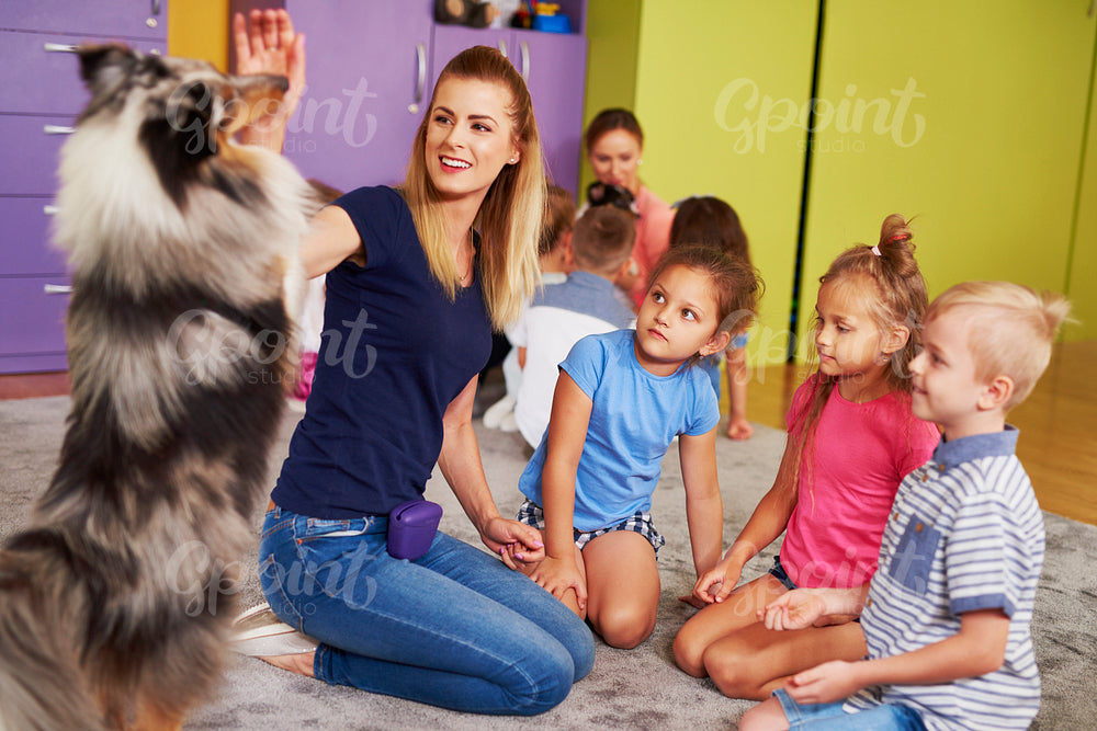 Happy child with dog in the preschool