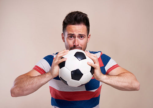 Nervous soccer fan with soccer ball