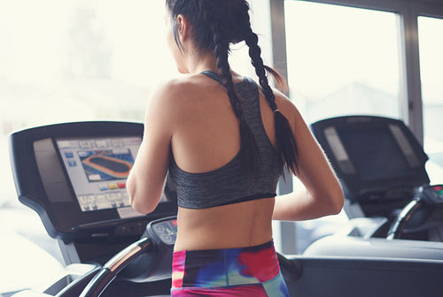 Confident woman running on treadmill