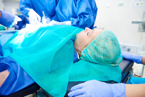 Woman being operated by surgeons