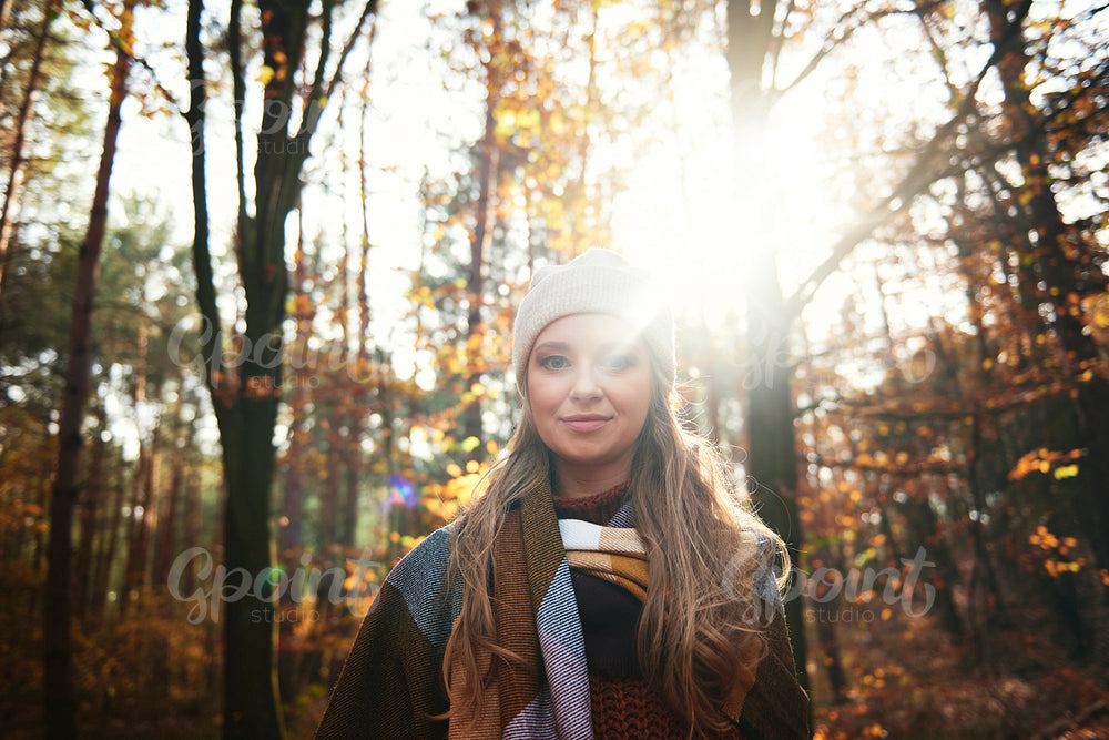 Portrait of young woman in autumnal forest