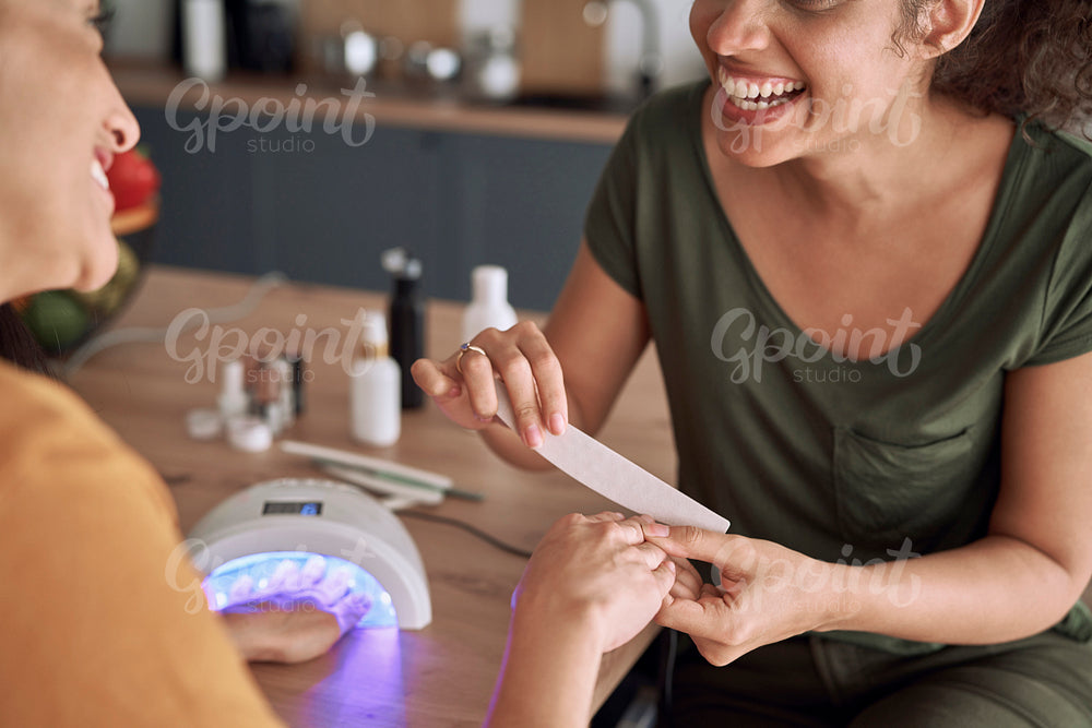 Close up of happy woman doing manicure at home