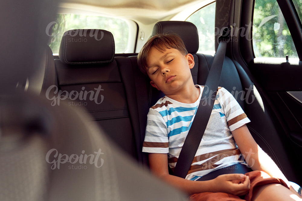 Boy sleeping while riding in car