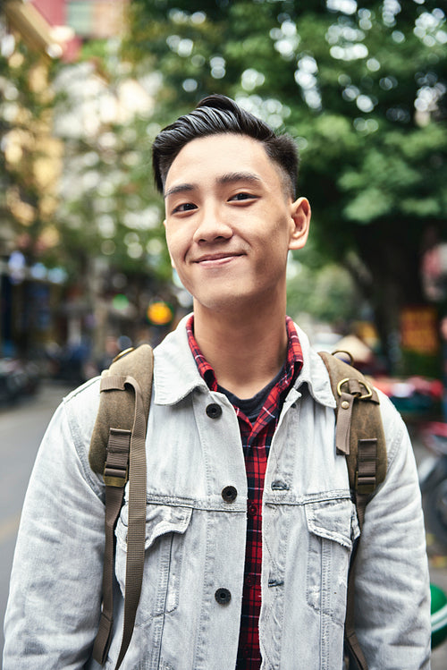 Portrait of young Vietnamese man with backpack in the city
