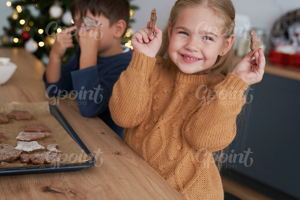 Cute girl showing homemade gingerbread cookies