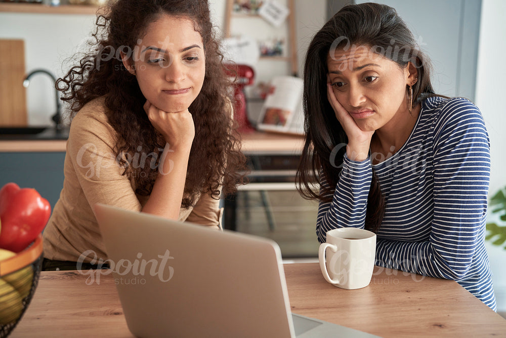 Two dissatisfied women during a video call at home