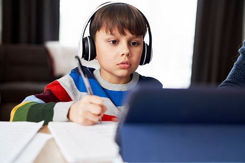Boy in headphone during homeschooling