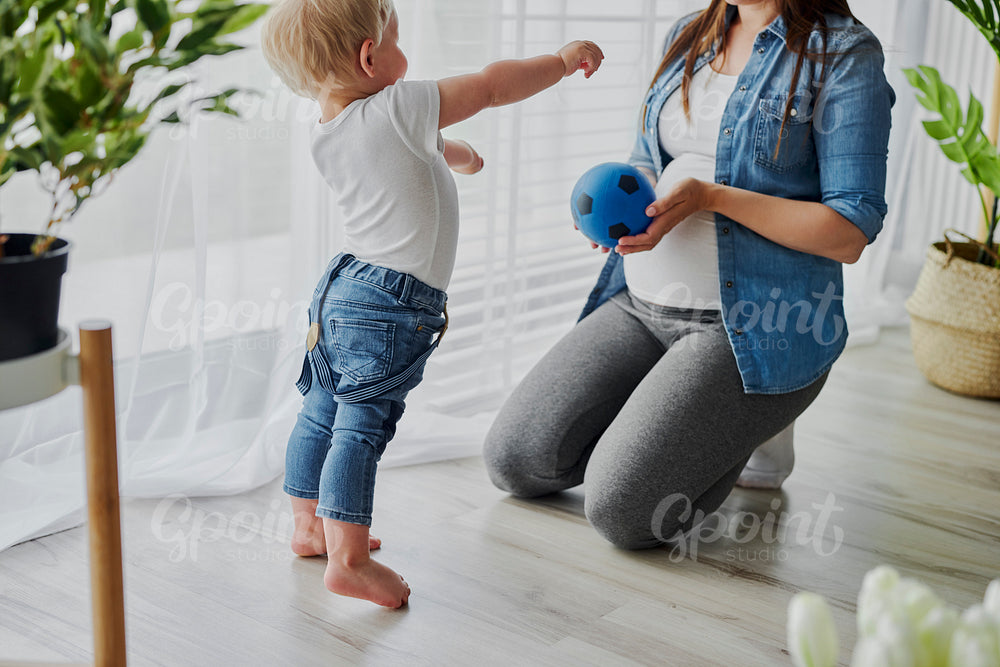 Pregnant woman playing with her toddler son