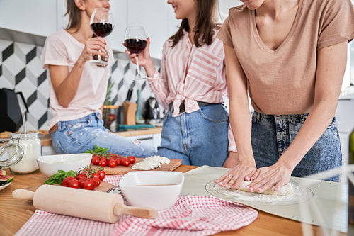 Girls having good time with homemade pizza and wine