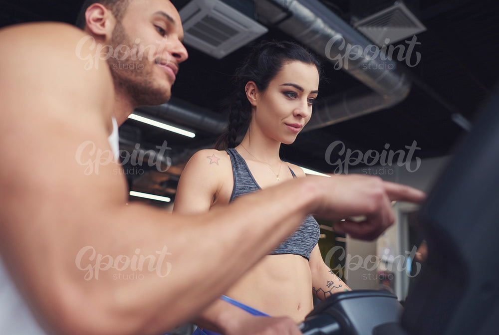 Personal trainer guiding sports woman