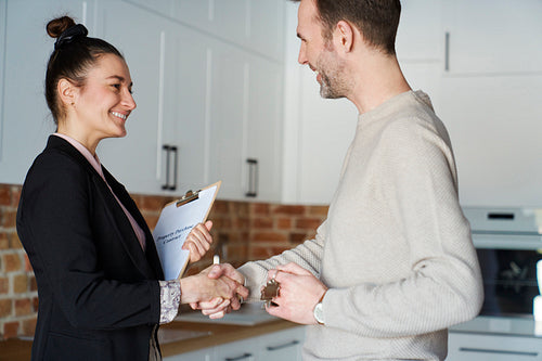 Estate agent  in the handshake of a satisfied customer