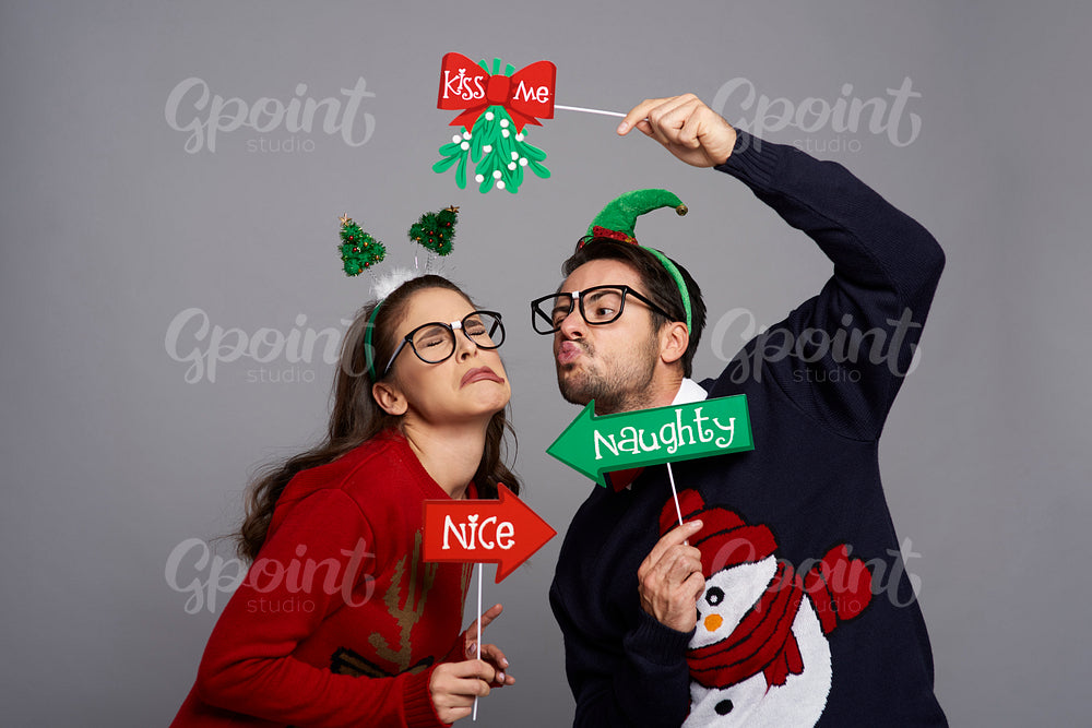 Nerdy man kissing disgusted woman