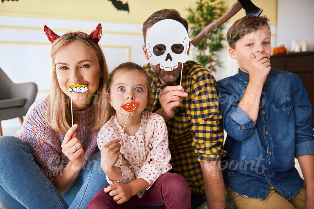 Portrait of happy family spending Halloween together at home