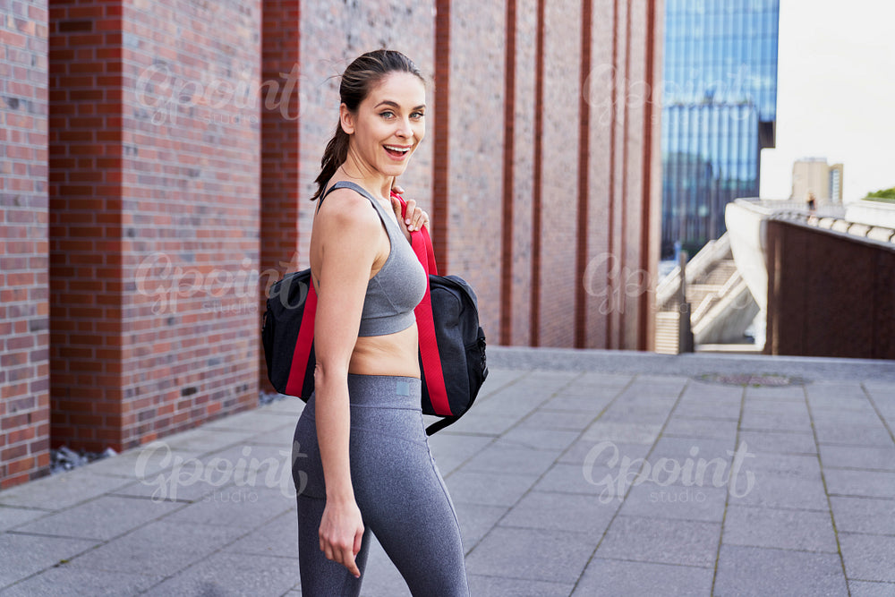 Rear view portrait of woman in training clothes outdoor