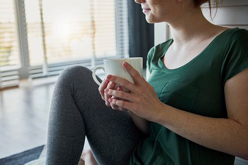 Woman relaxing with a cup of hot tea