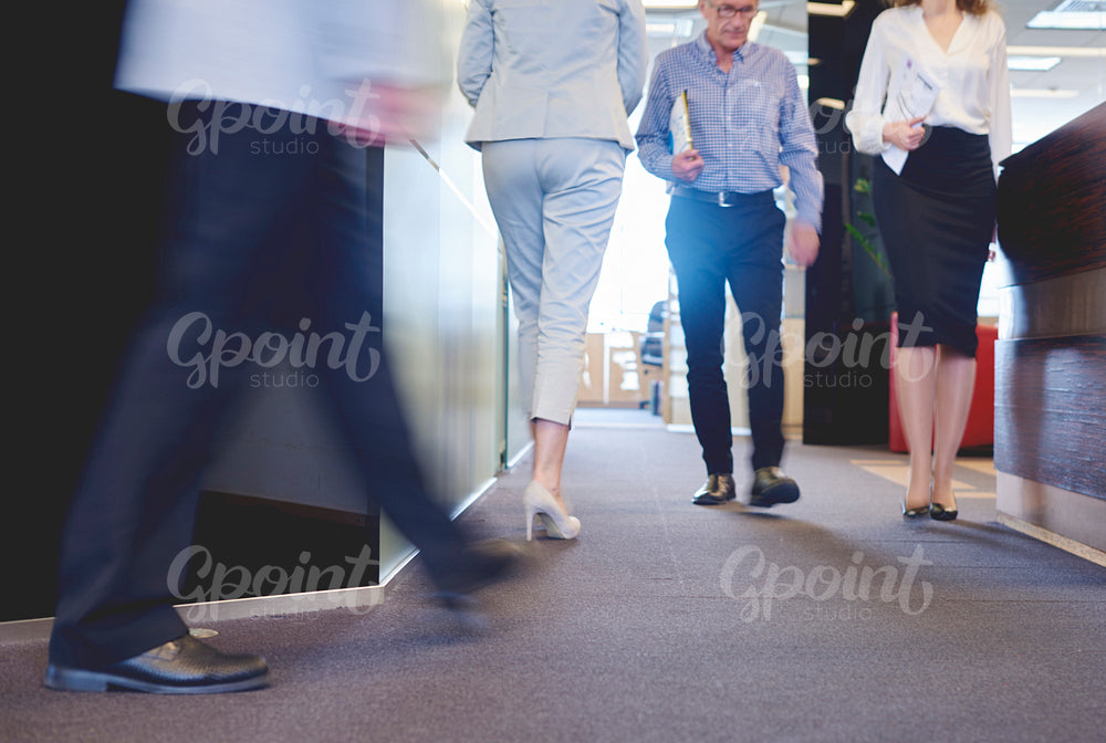 Low section of coworkers in corridor