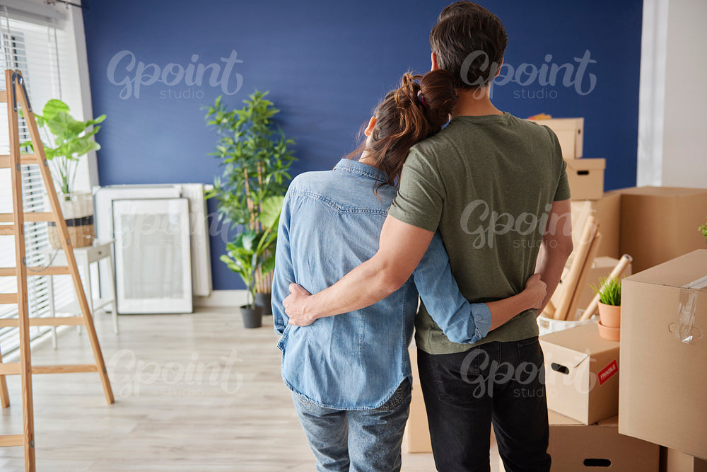 Rear view of couple looking at new house