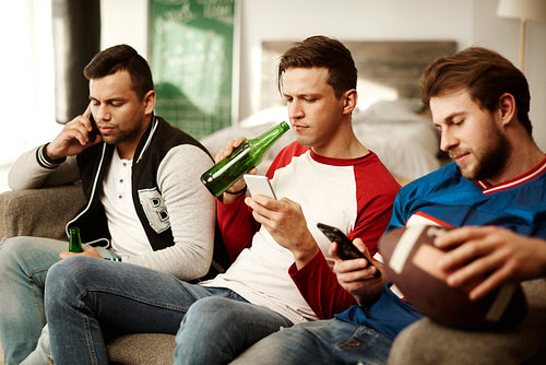 Men using mobile phone during commercial break