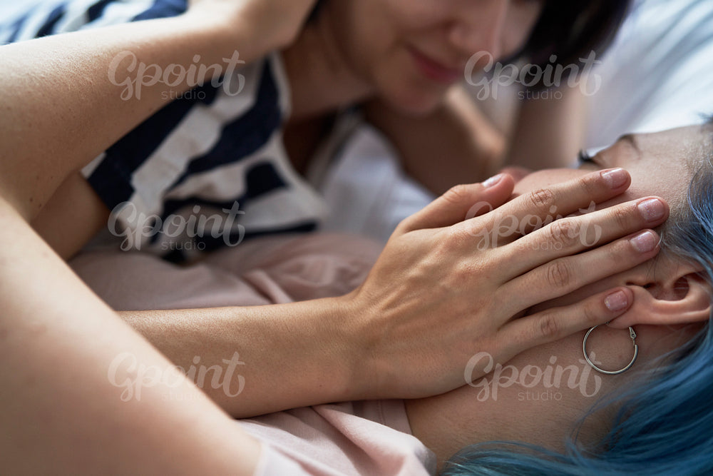 Close up of lesbian couple lying on bed
