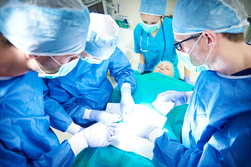 Female and male surgeon during an operation