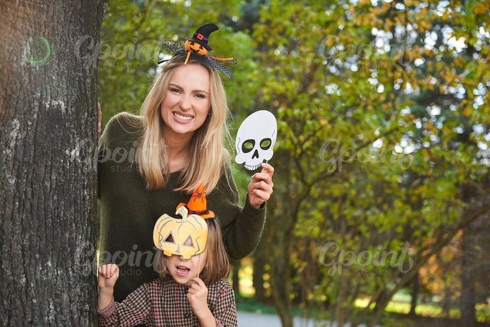 Mother and her daughter in halloween masks
